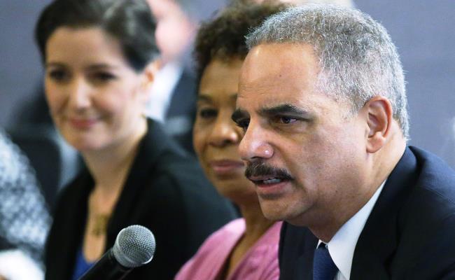 U.S. Attorney General Eric Holder (foreground) speaks during a Building Community Trust roundtable meeting on February 5, 2015 in Oakland, California.  Shown behind him is Rep. Barbara Lee (D, Calif.) (Justin Sullivan/Getty Images)