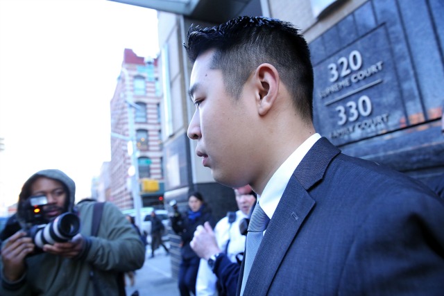 New York City police officer Peter Liang is escorted out of court after he was charged with manslaughter, official misconduct and other offenses on February 11, 2015 in the Brooklyn borough of New York City. Liang pleaded not guilty Wednesday in the November 20 death of 28-year-old Akai Gurley. Liang claims he fired his gun accidentally in a stairwell in the Pink Houses, a public housing complex in East New York. Liang was released without bail. The Brooklyn courtroom was packed with officers and protesters.