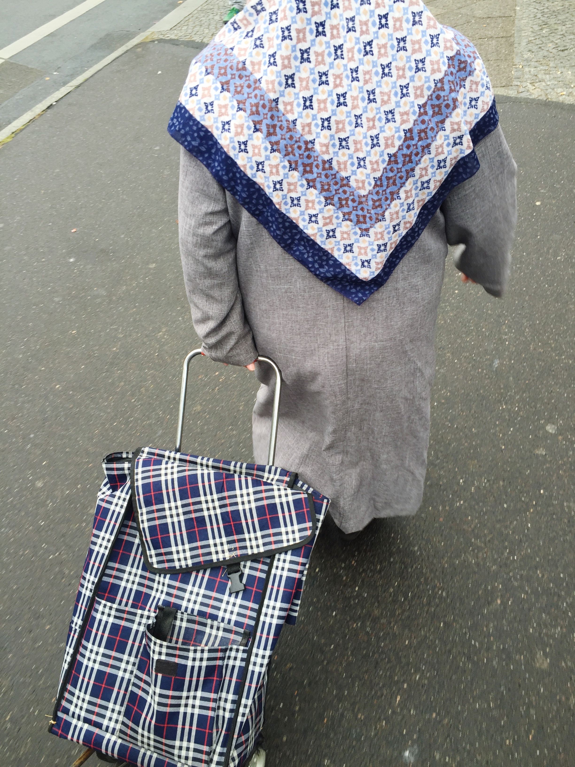 Rear View Of Woman Walking With Bag On Street