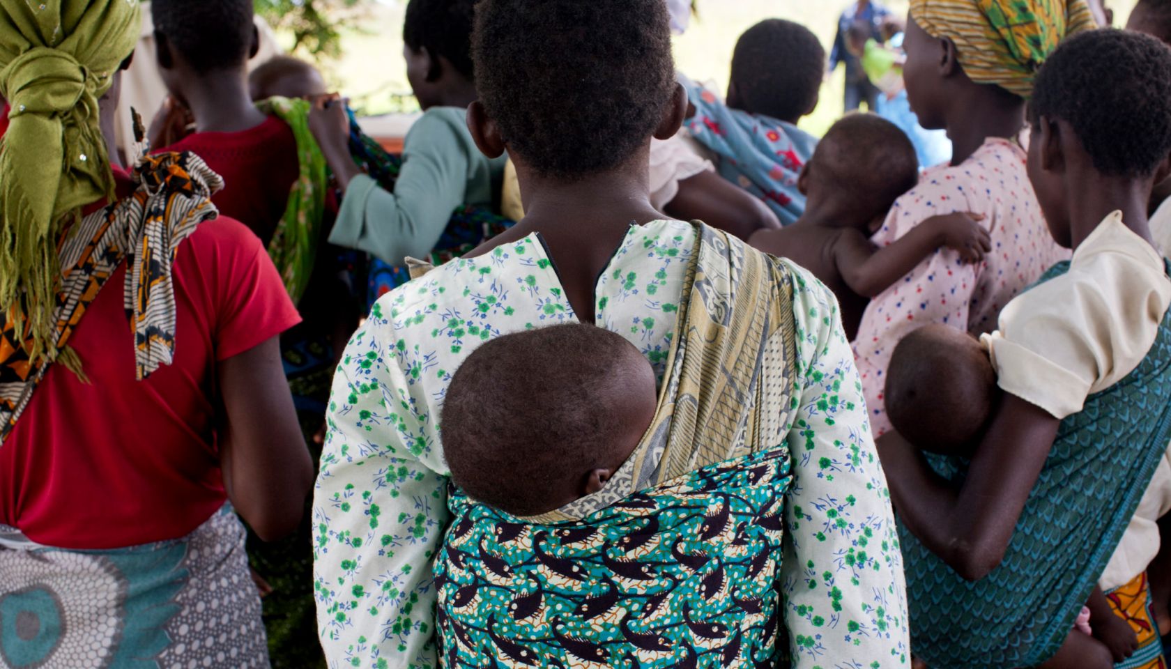 Mothers carrying children and waiting at rural health clinic