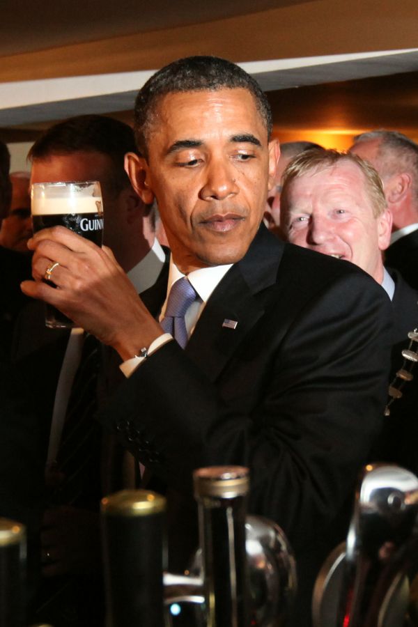 US President Barack Obama reacts after t