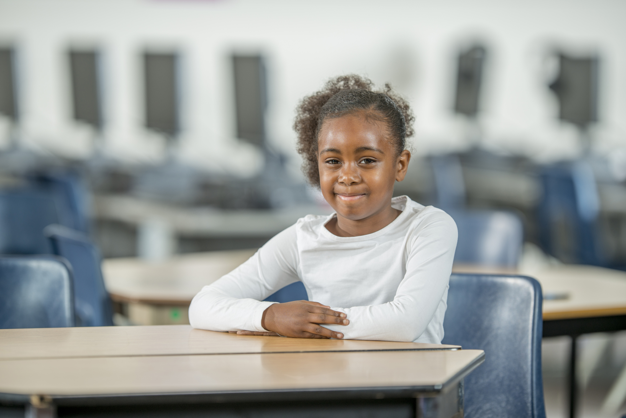 Young Student Sitting at Her Desk