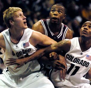 BOULDER, CO (JANUARY 13, 2007) -- Buffs Sean Kowal, left, (41) and Dominque Coleman, right, (11) tried to box out Aggie forward Joseph Jones on a rebound from a free-throw in the first half Saturday evening. The Colorado Buffaloes hosted the Aggies of Tex