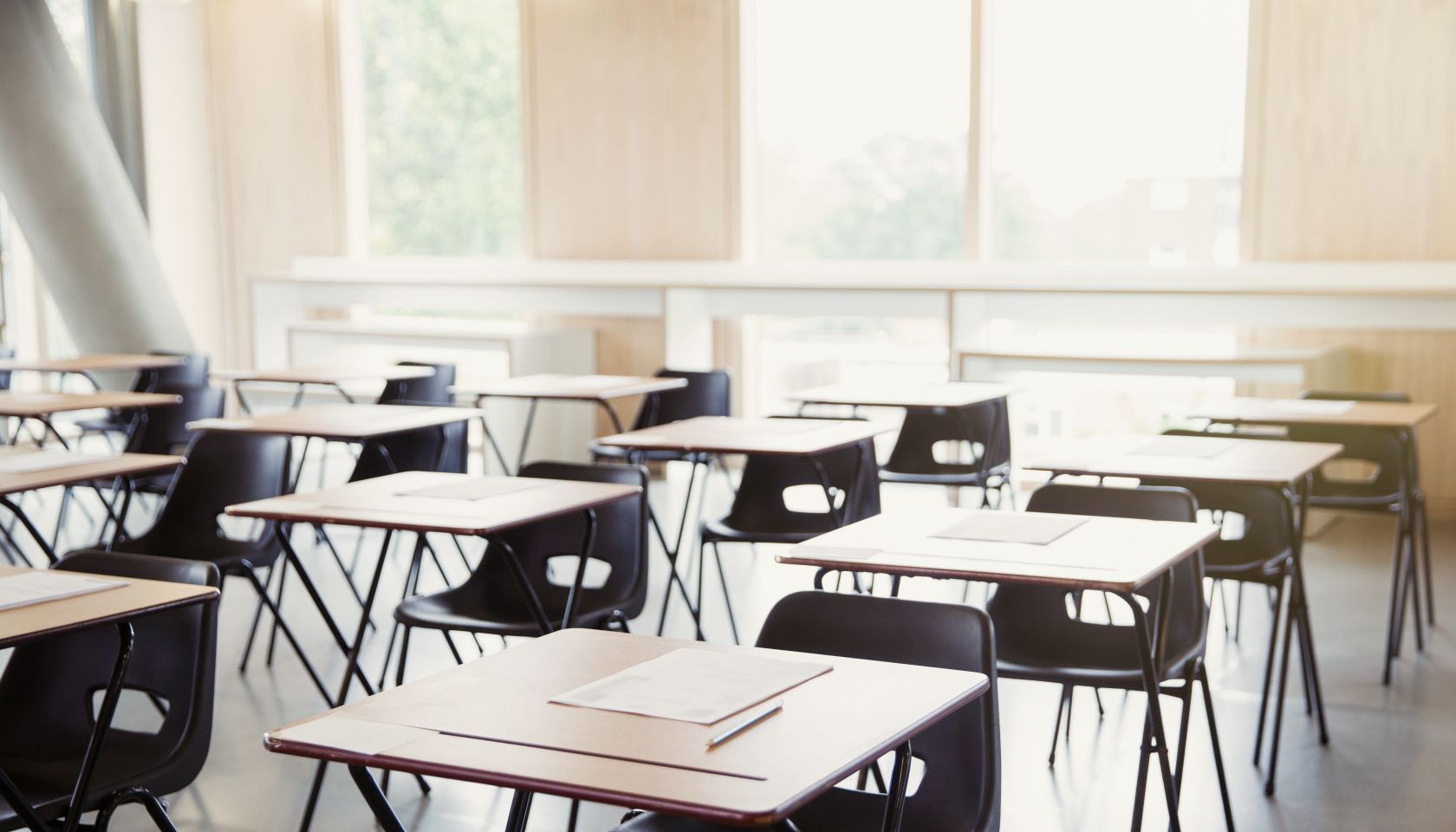 Tests on desks in empty classroom