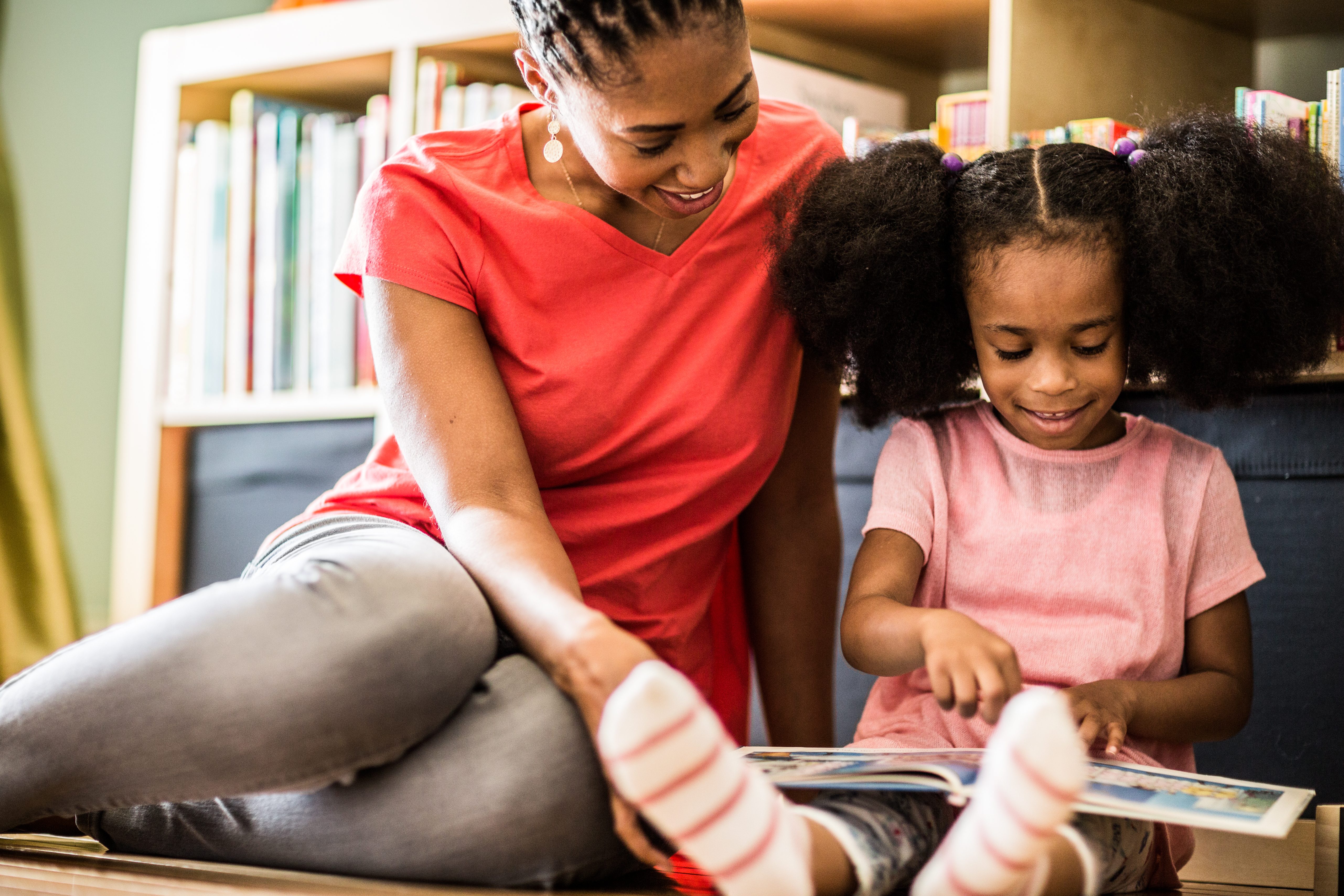 mother and daughter reading at home