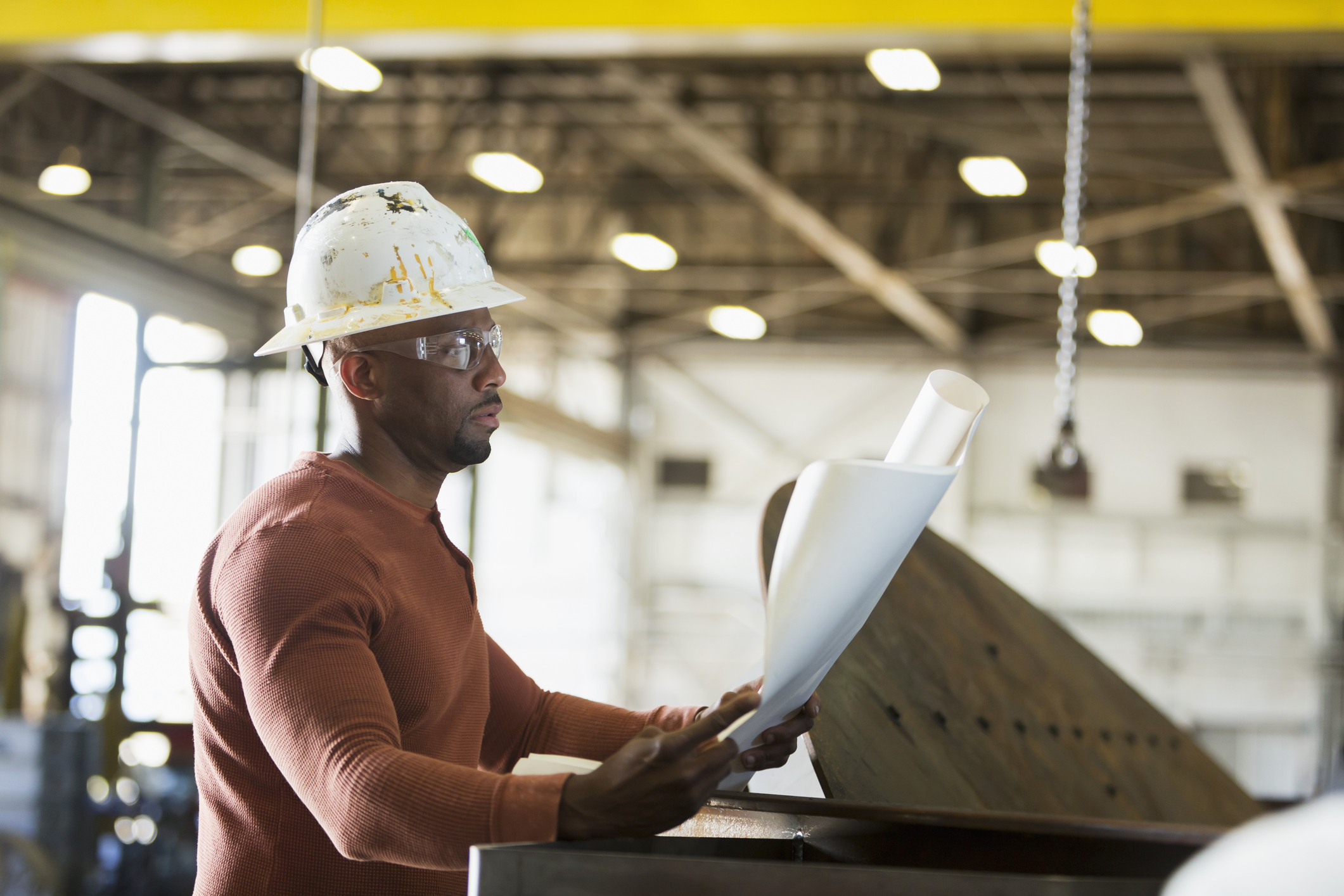 Manual worker with set of plans