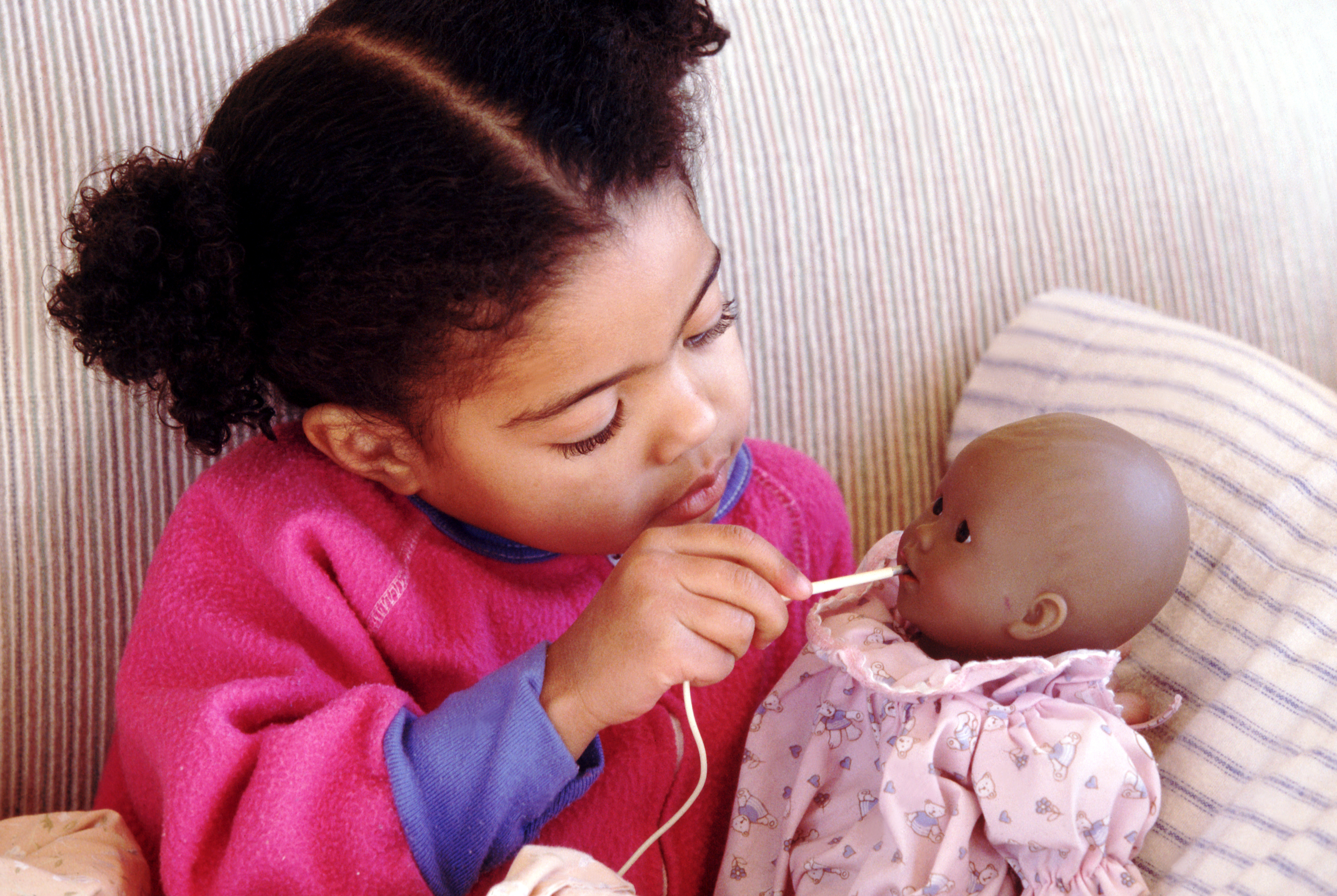Child caring for sick doll