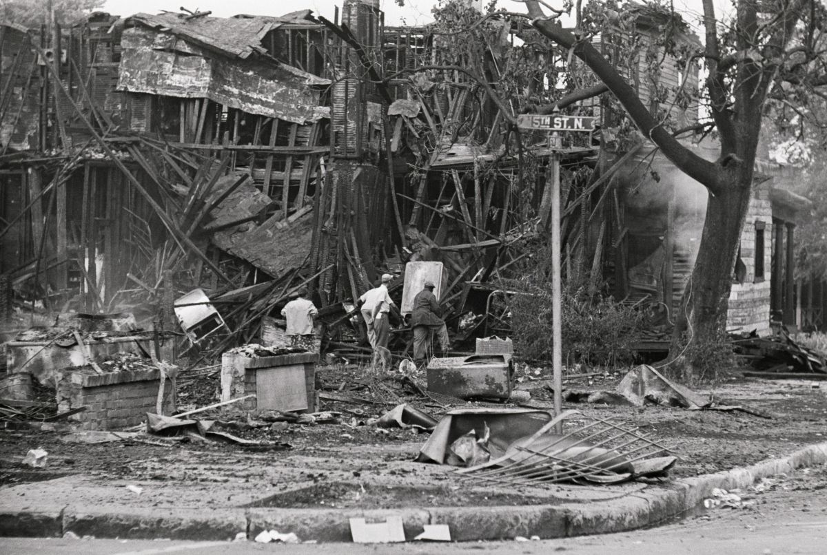 Men Searching Wreckage of Burned Building