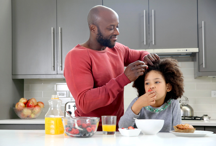 Dad fixes daughter's hair