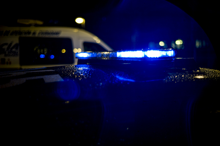 Spain, Madrid, rain falling on a police car at night