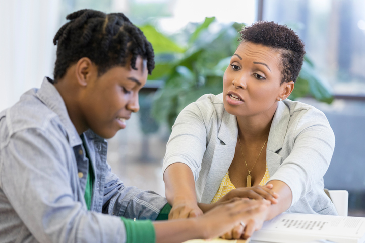 Mom helps frustrated son with homework assignment