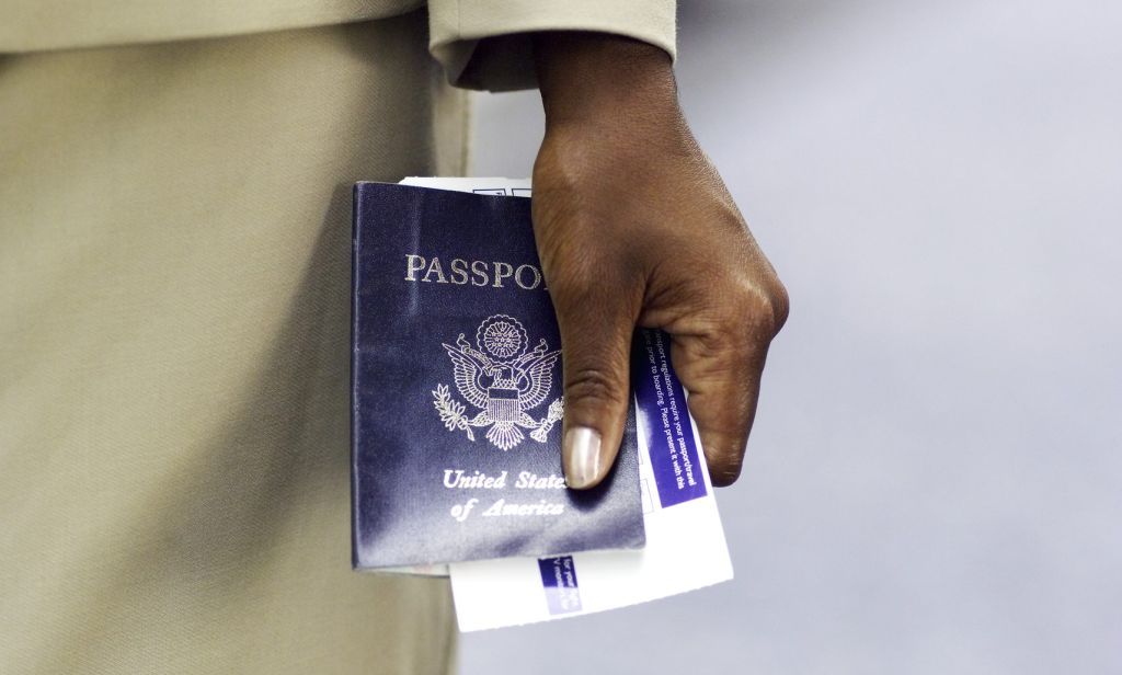 close up of businesswoman's hand holding passport and ticket