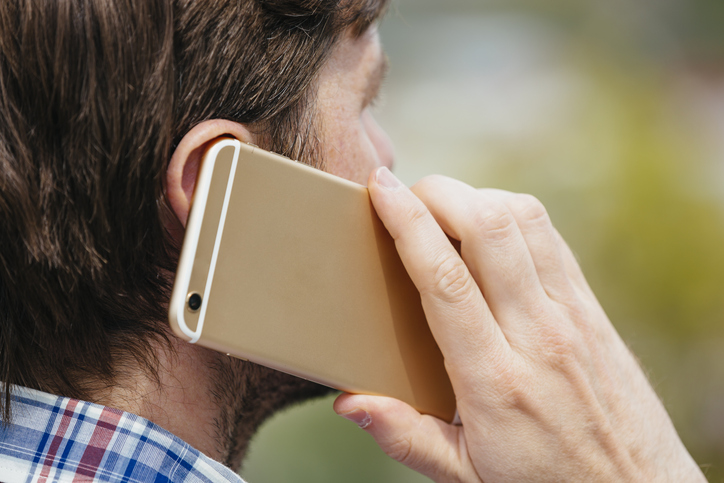 Man talking on a mobile phone, close up