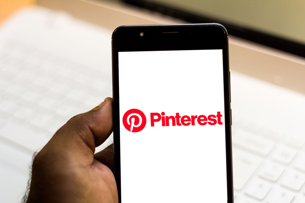 In this photo illustration the Pinterest logo is seen...