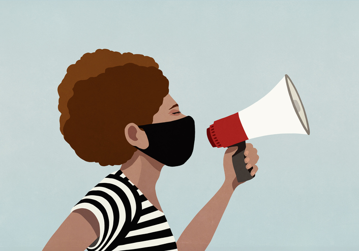 Black woman in face mask using megaphone