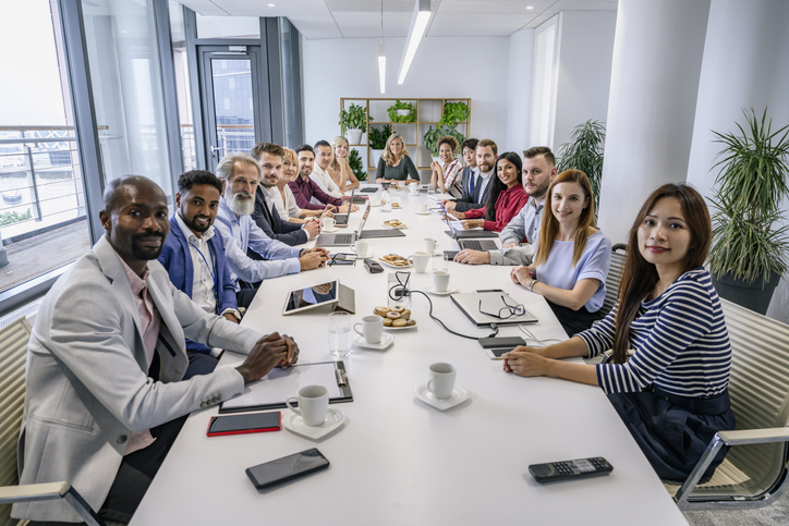 Portrait of diverse executive team seated in board room