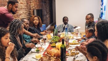 Multi-generation ethnic family having Thanksgiving dinner