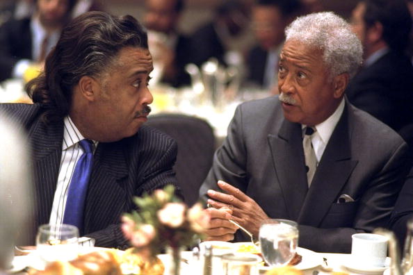 The Rev. Al Sharpton (left) confers with former Mayor David