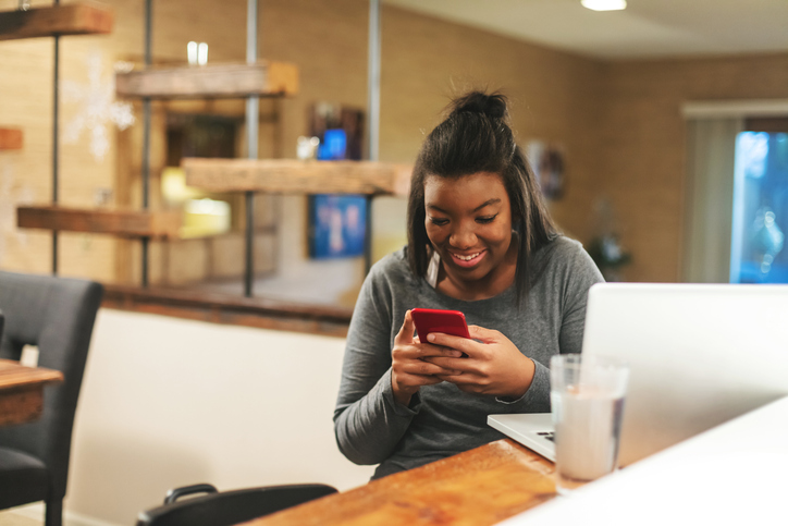 African American Generation Z Female Getting News on College Funding at Home