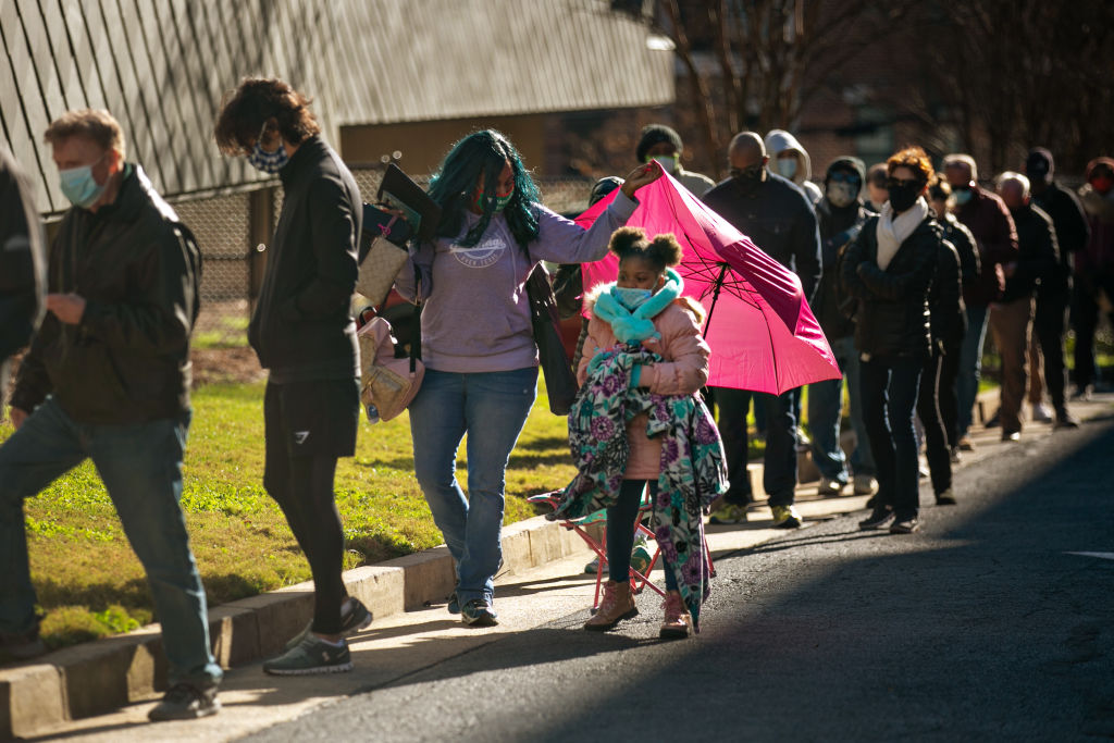 Voters wait in a long line to vote in Atlanta on the first day of In-person early voting for the iGeorgia Senate runoff election