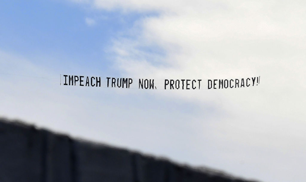 A banner towed by a plane calls for the impeachment of U.S.