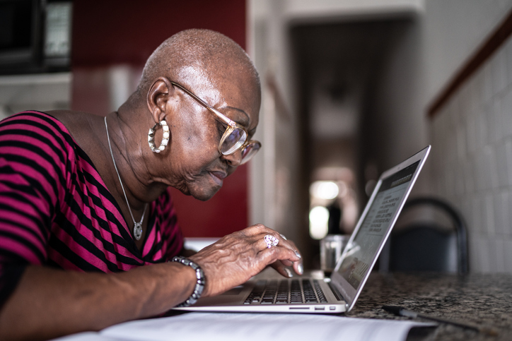 Senior woman using laptop at home
