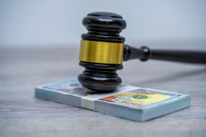 Judge's hammer gavel and bank note.Representation of corruption and bribery in the judiciary.