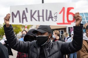 Black Lives Matter activist holds a placard protesting the...
