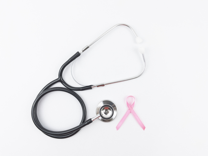 Sign of Breast cancer awareness month, pink ribbon with Stethoscope. White Background.