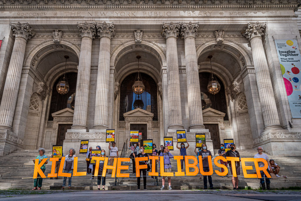 Protesters seen holding a banner reading KILL THE FILIBUSTER...