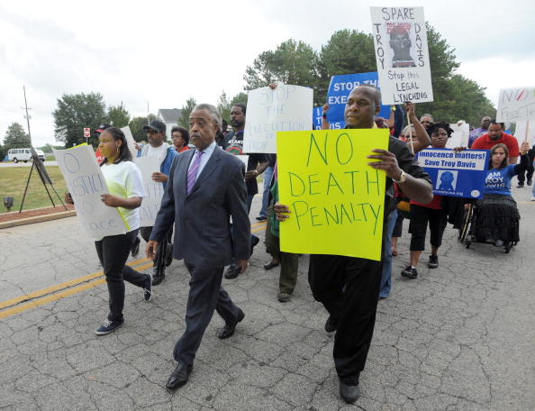 Rev. Al Sharpton leads a group of demons