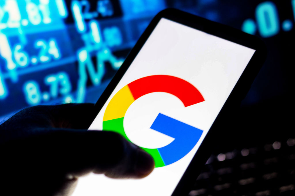 In this photo illustration the Google logo seen displayed on...