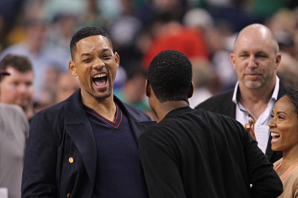 Boston, MA - Comedian/actor Chris Rock, center, gets a laugh out of Will Smith and Jada Pinkett-Smith at Game 5 of the Eastern Conference Semifinals at TD Garden on Monday, May 21, 2012. Staff Photo by Matthew West.