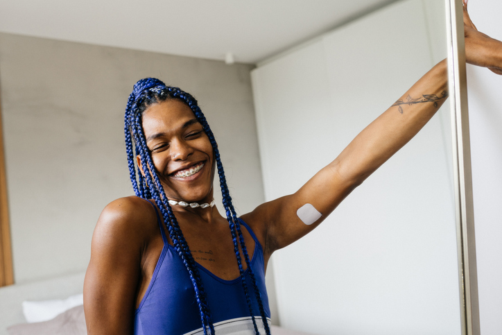 Smiling trans woman in the mirror