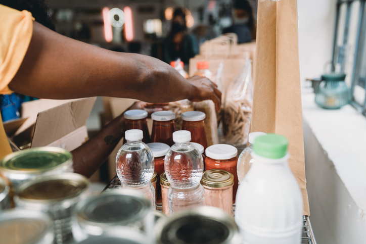 Close up photo of volunteers preparing donation boxes with food at the food and clothes bank