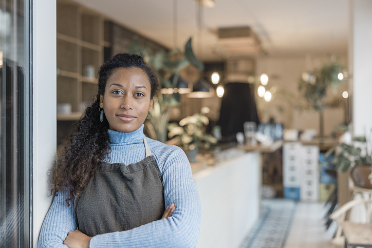 Portrait of a small business owner near the store door