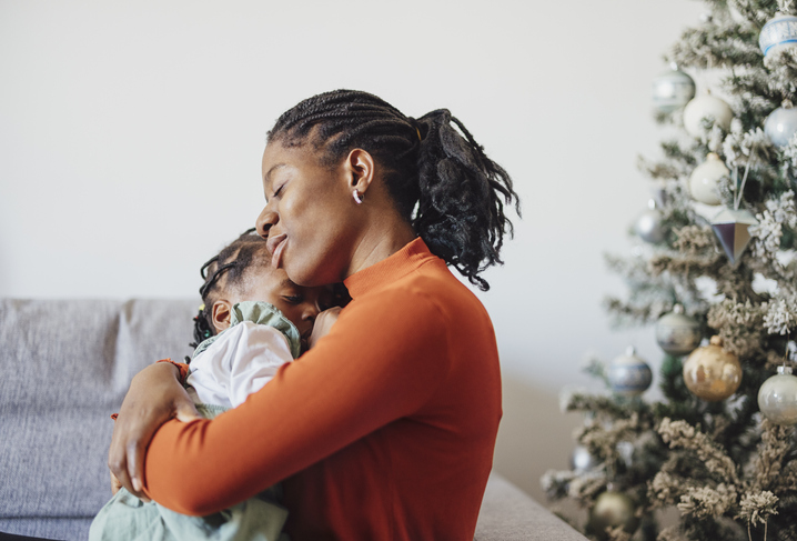 Happy Mother Embracing her Daughter at Home