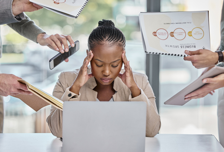 Shot of a young businesswoman looking stressed and frustrated in a meeting at work