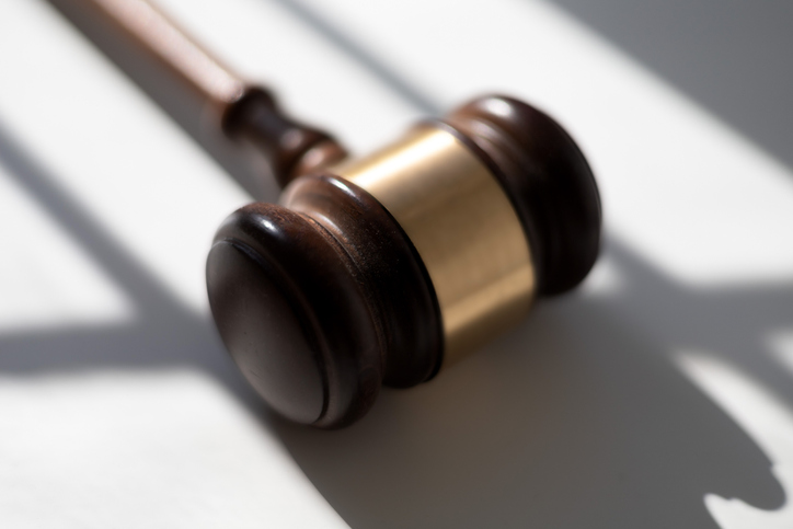 judge’s traditional wooden gavel on white background & shadow detail