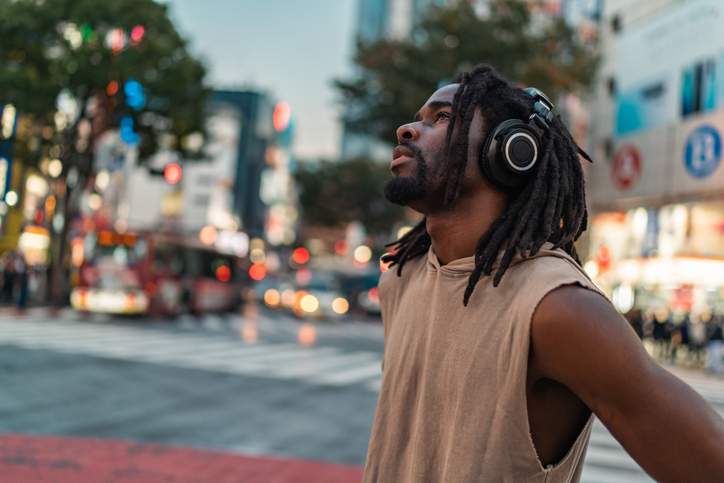 Portrait of handsome Black-ethnicity man with basketball in city