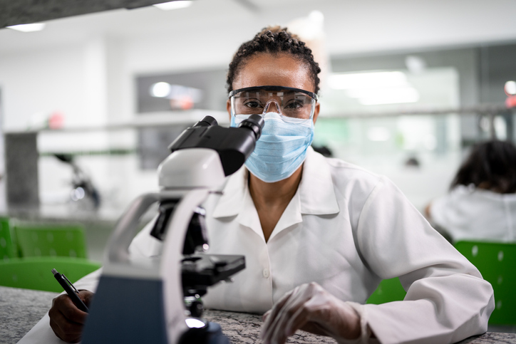 Portrait of woman in the laboratory - using a face mask against COVID
