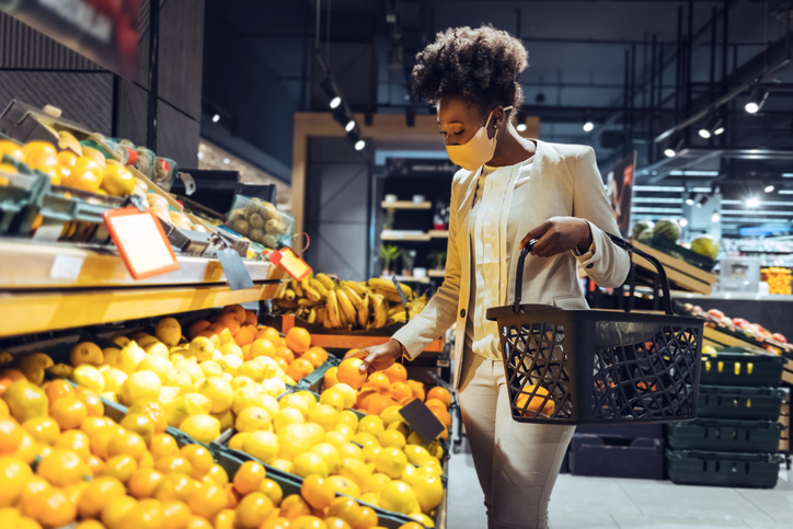 Shot of a young woman browsing through the produce section of a grocery store