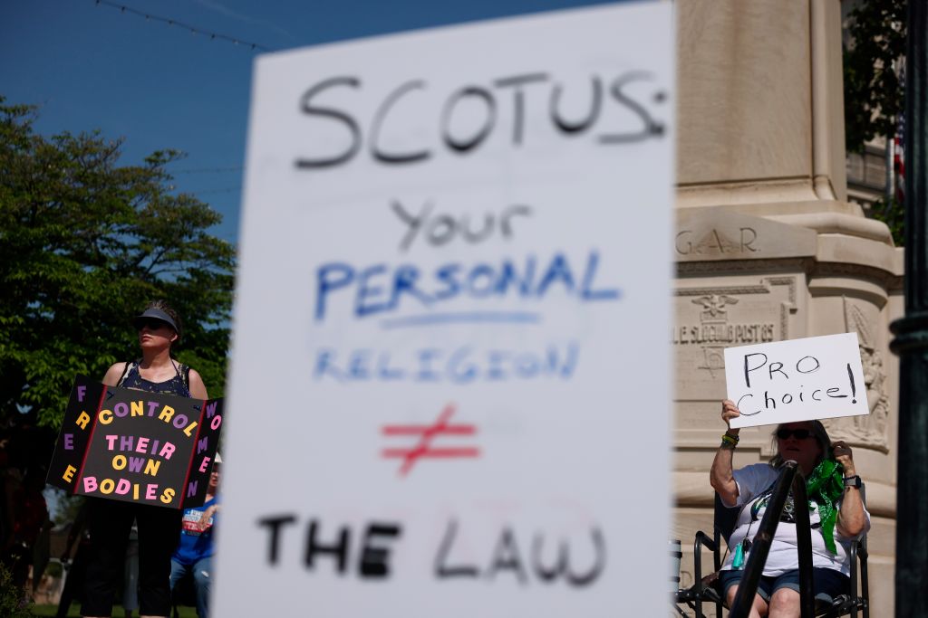A protester holds a placard expressing her opinion during a...