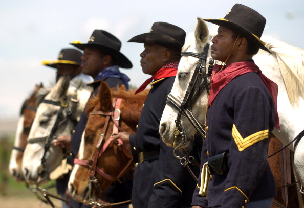 (ga) CDCIVILWAR--AURORA, COLORADO, MAY 2 2007-- Actors dressed as post-Civil War African-American calvary soldiers, stand at attention during a hands-on Civil War learning experience at Delaney Farm in Aurora. The re-enactment of the all-black regiment, b