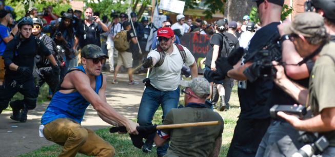 A member of the white supremacist and a protester are seen...