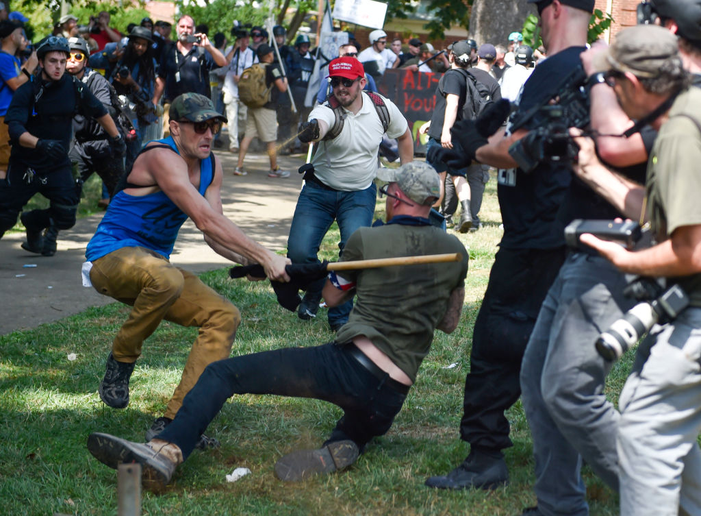 A member of the white supremacist and a protester are seen...
