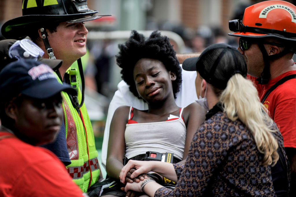 A young woman is surrounded by the rescue team, she appears...