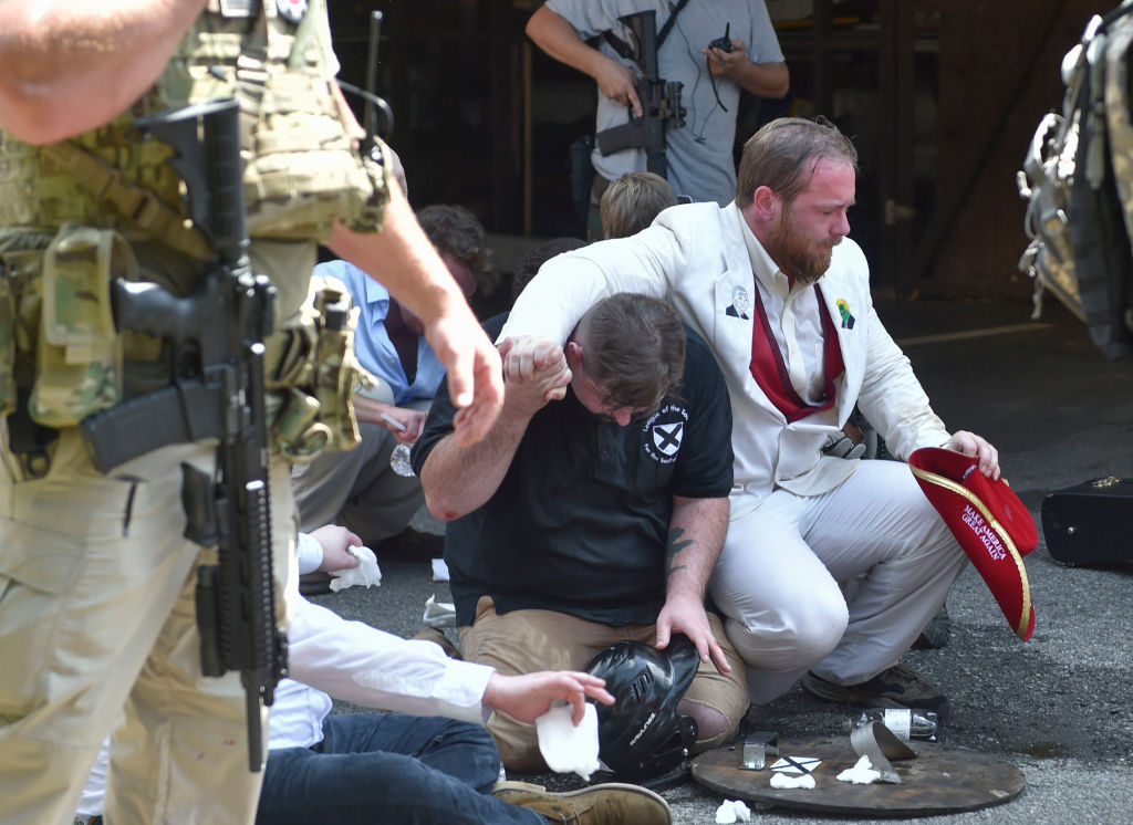 Men are seen sitting on the ground during the State of...