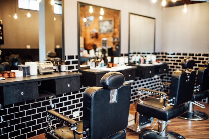 Empty black chairs and mirrors in barber shop