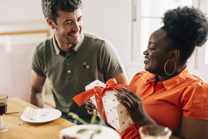 A Beautiful Happy Woman Getting A Gift For Her Birthday From Her Smiling Boyfriend